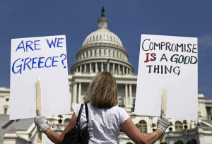 A demonstrator holds placards to protest U.S. debt in front of the Capitol in Washington